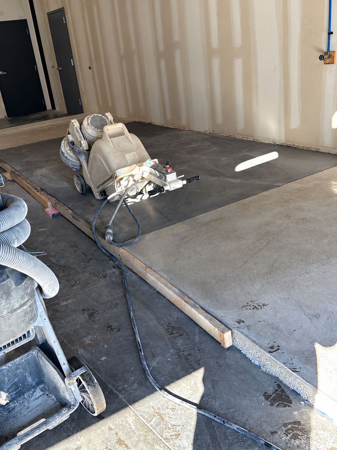 Concrete grinding machine preparing a commercial floor in Des Moines