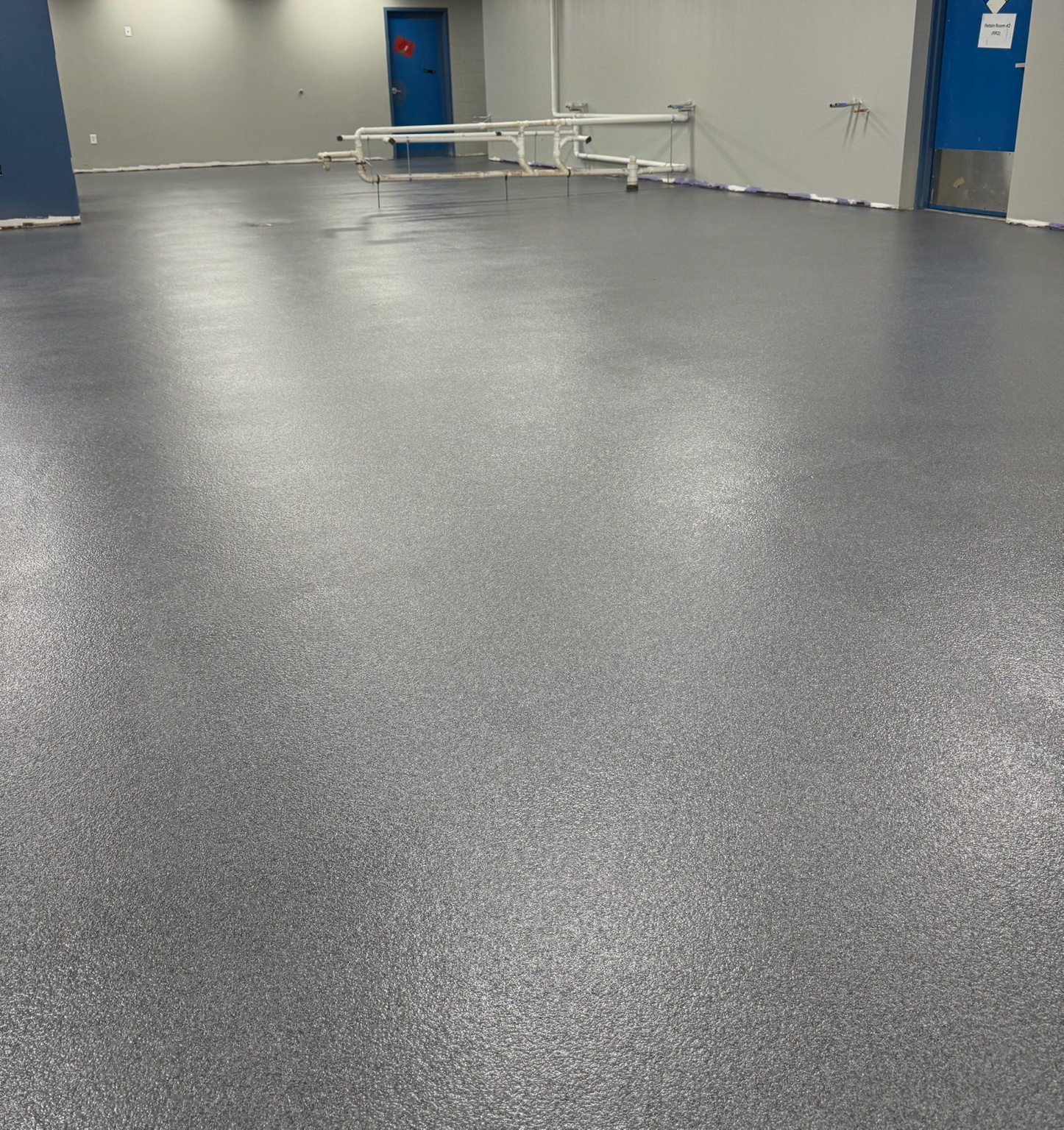 Finished gray epoxy flooring across a large Iowa commercial facility
